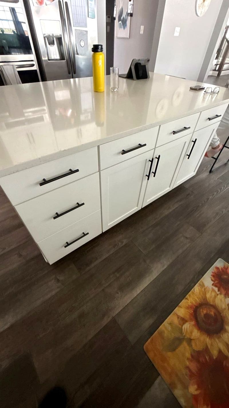 Repainted kitchen cabinets with black hardware