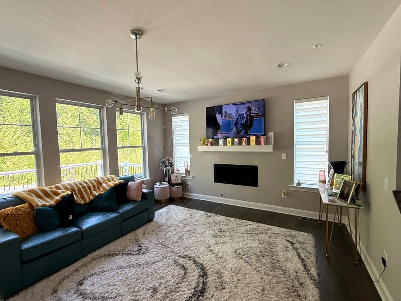Living room repainted by ARM Premium Painting — walls, ceiling and trim finished, furniture back in place