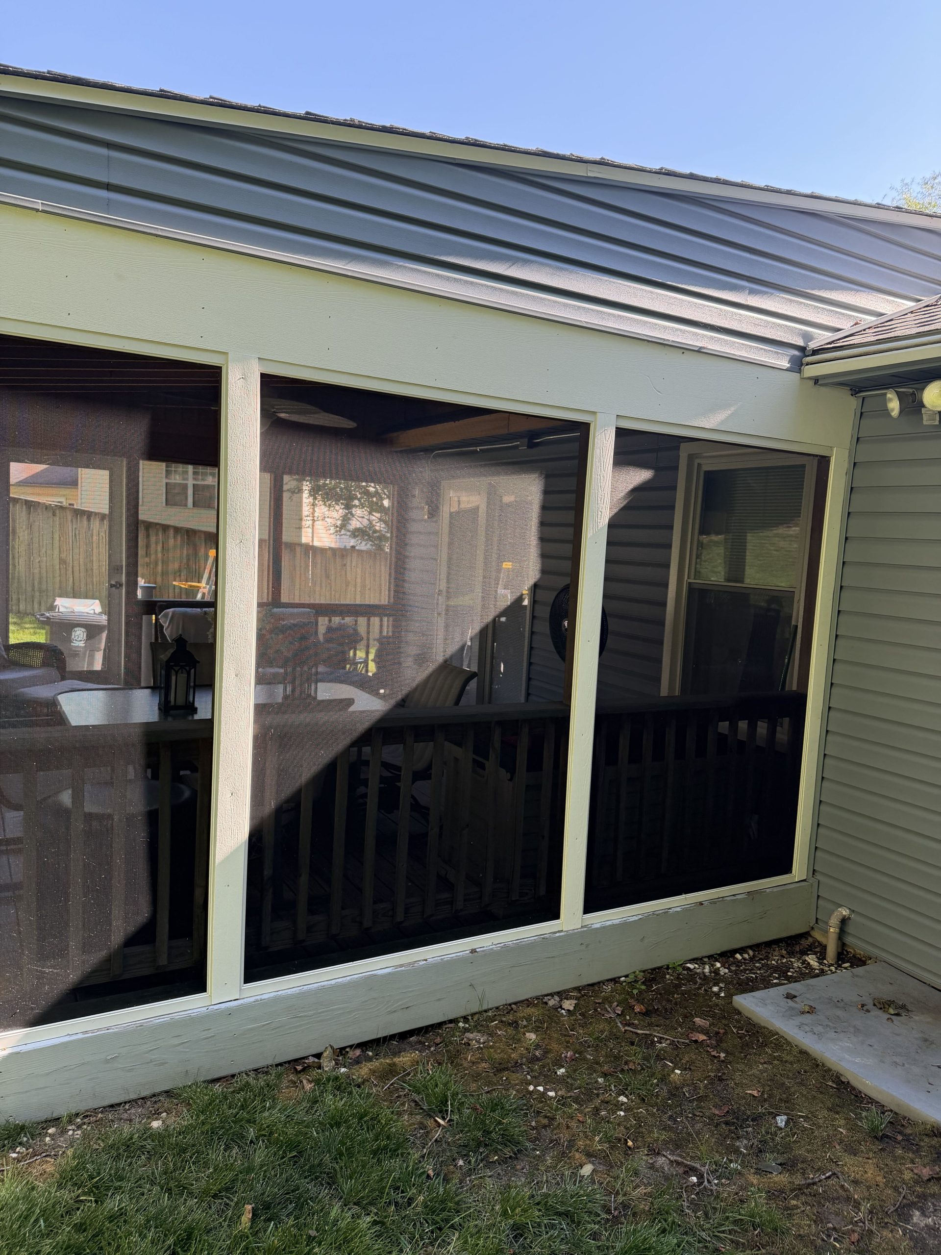 Screened porch before painting - faded yellowed trim