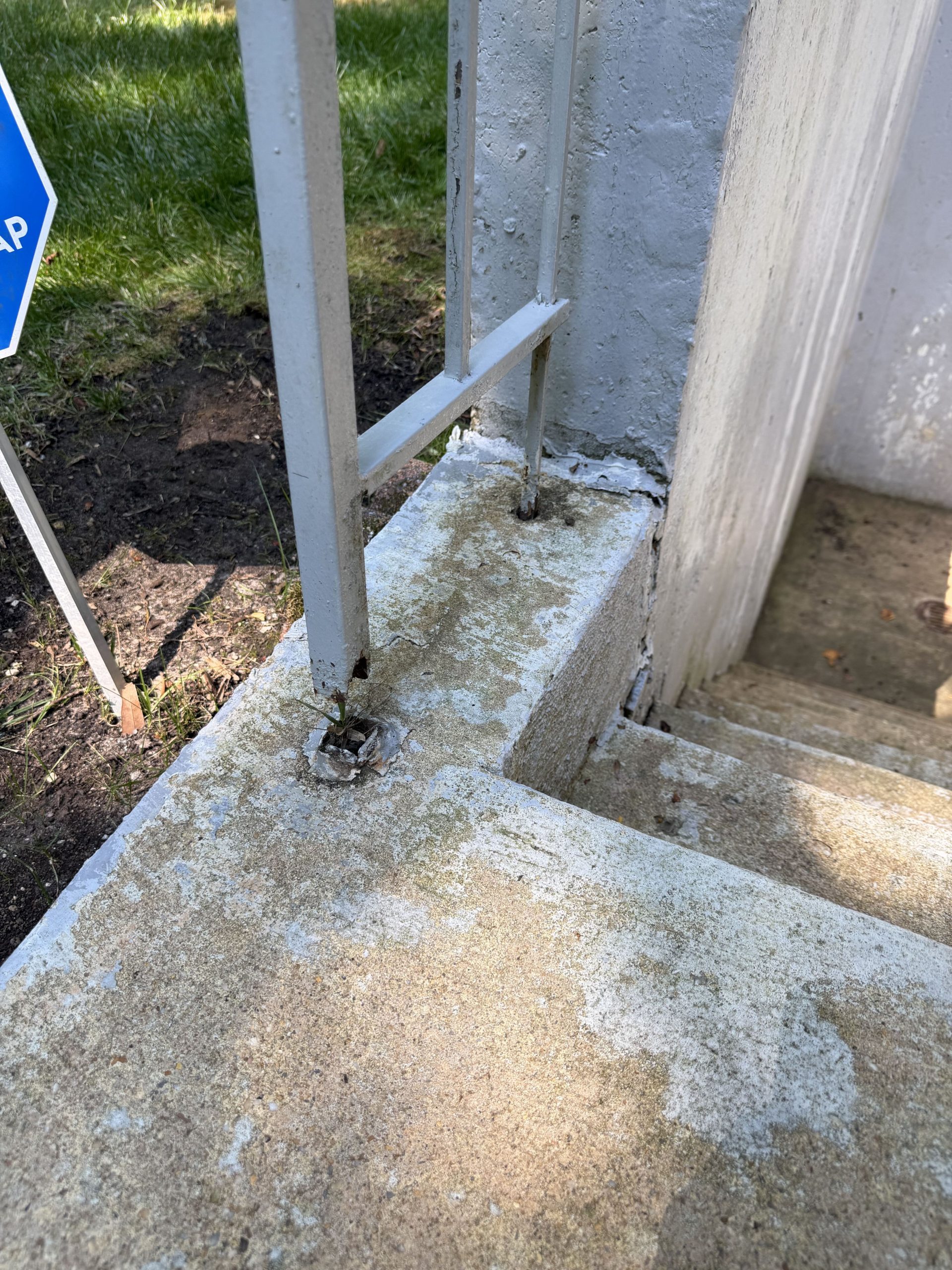 Concrete stair surround before painting - worn and stained
