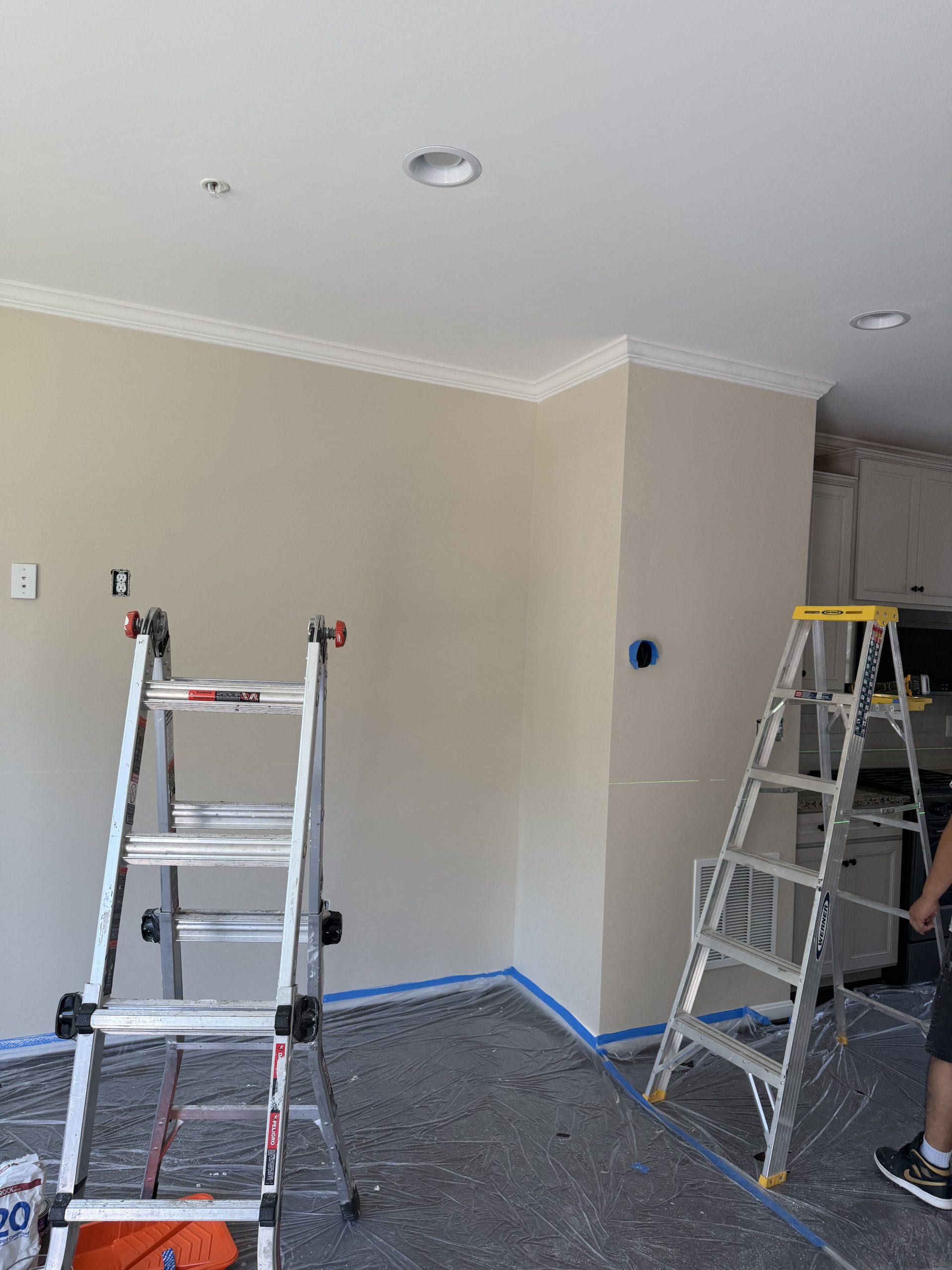 ARM Premium Painting crew professional setup with drop cloths and ladders in Millersville MD home