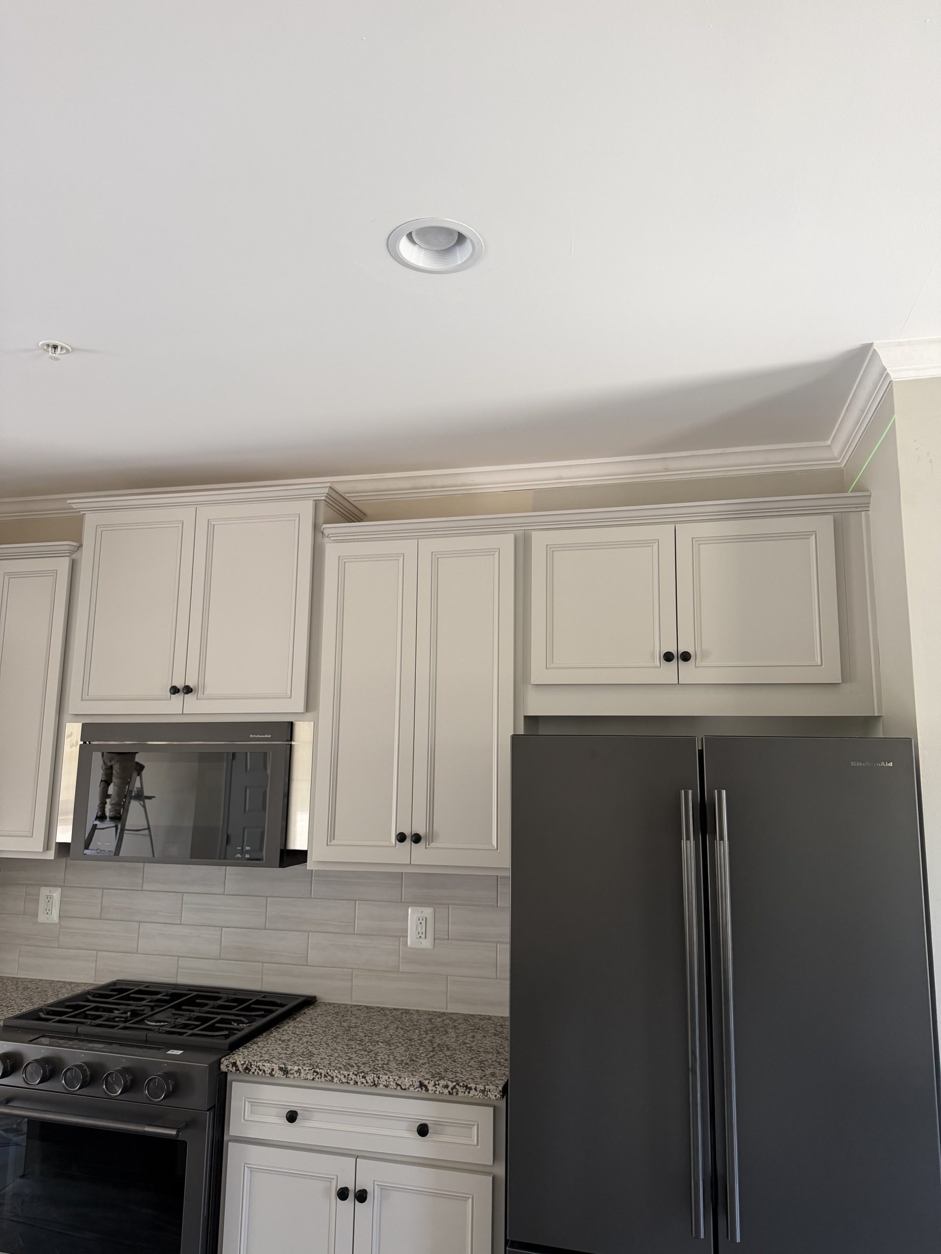 Cabinet painting in Millersville MD - freshly painted white kitchen cabinets by ARM Premium Painting