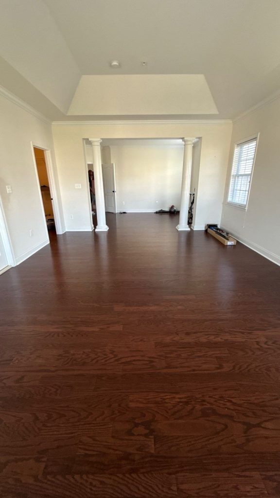 Freshly painted open living area with dark hardwood-look floors in Upper Marlboro, MD home