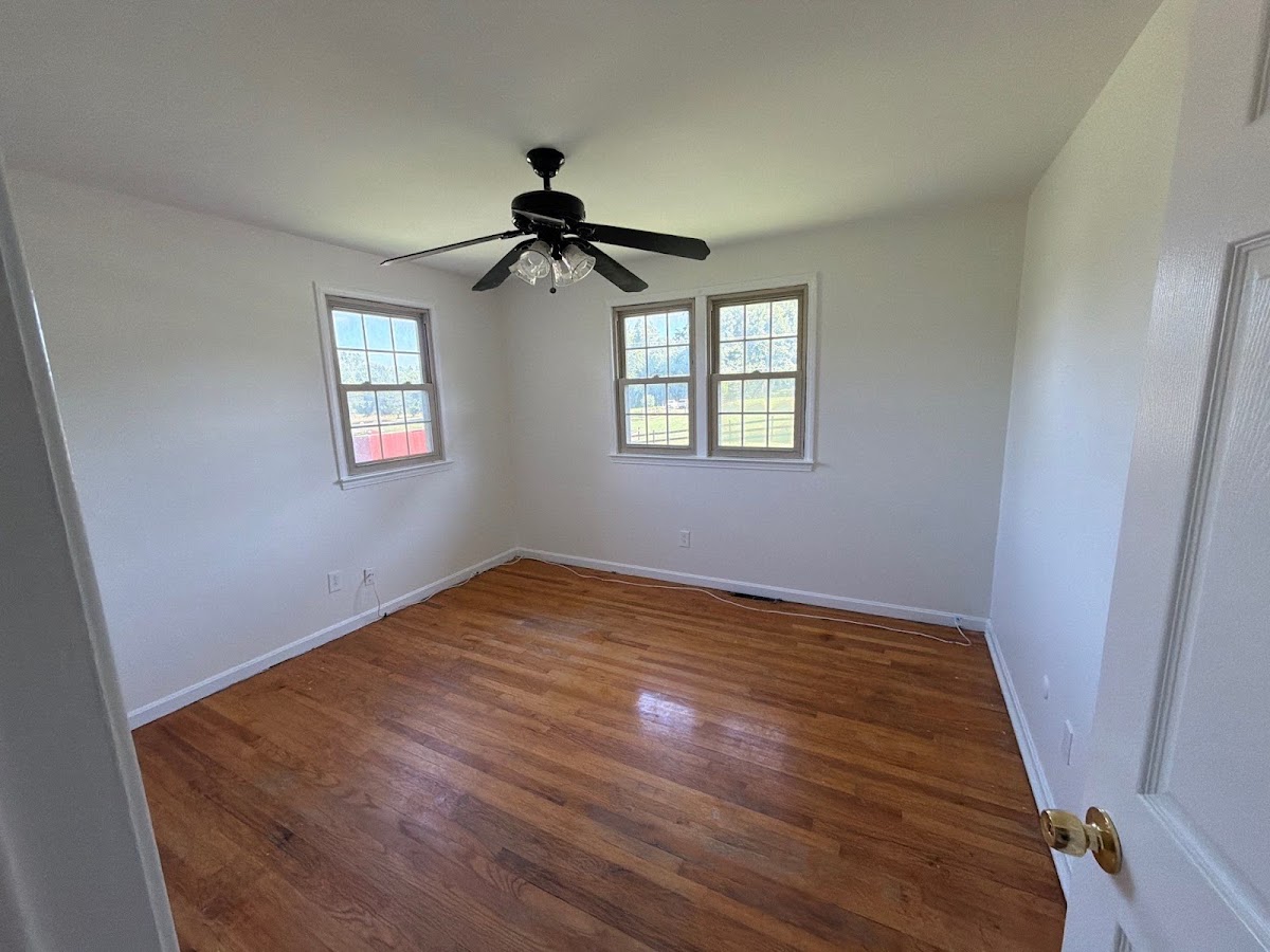 Freshly painted bedroom with clean walls and trim finished by ARM Premium Painting in Upper Marlboro, MD