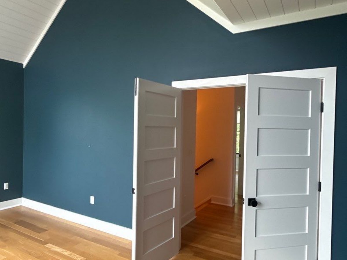Freshly repaired vaulted ceiling drywall with newly painted white doors in an Upper Marlboro, MD home by ARM Premium Painting