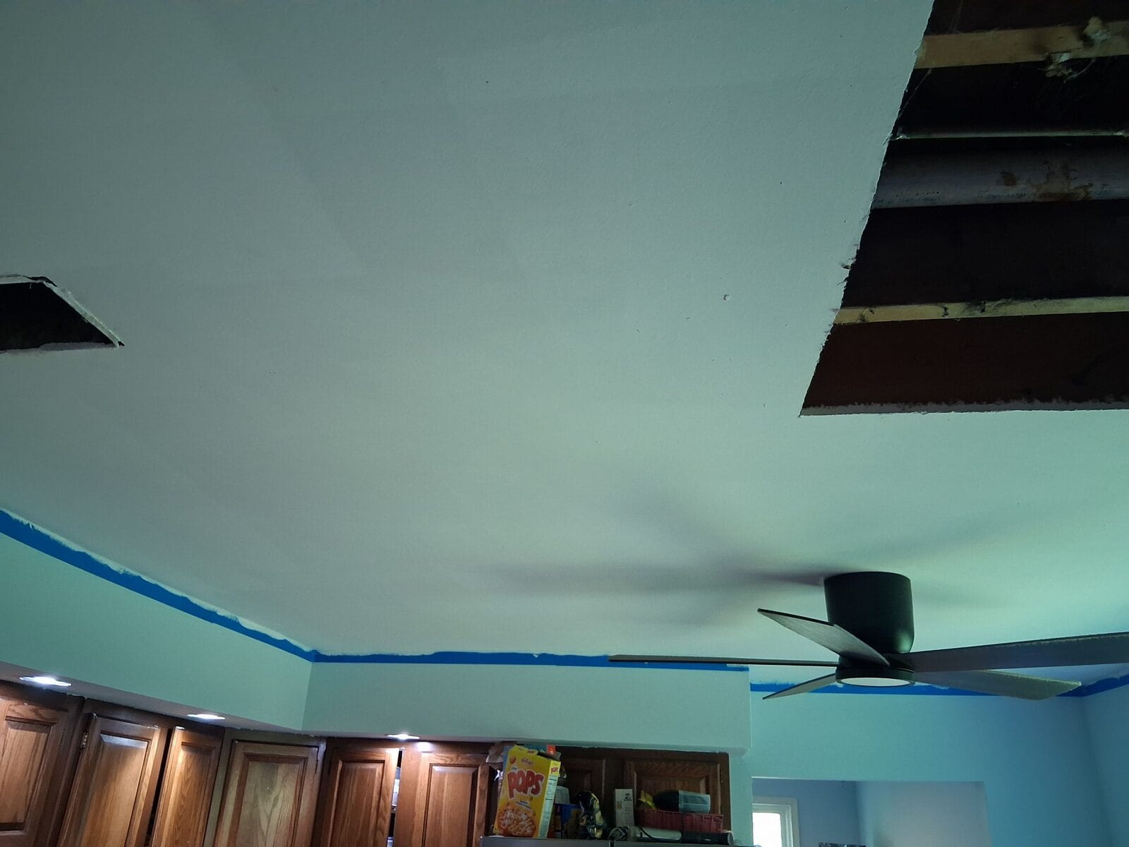 Ceiling opening cut back to sound material before a drywall repair