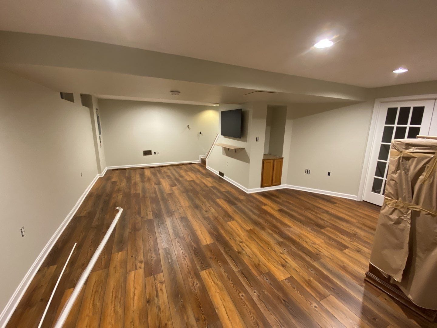Finished basement with luxury vinyl plank flooring installed by ARM Premium Painting