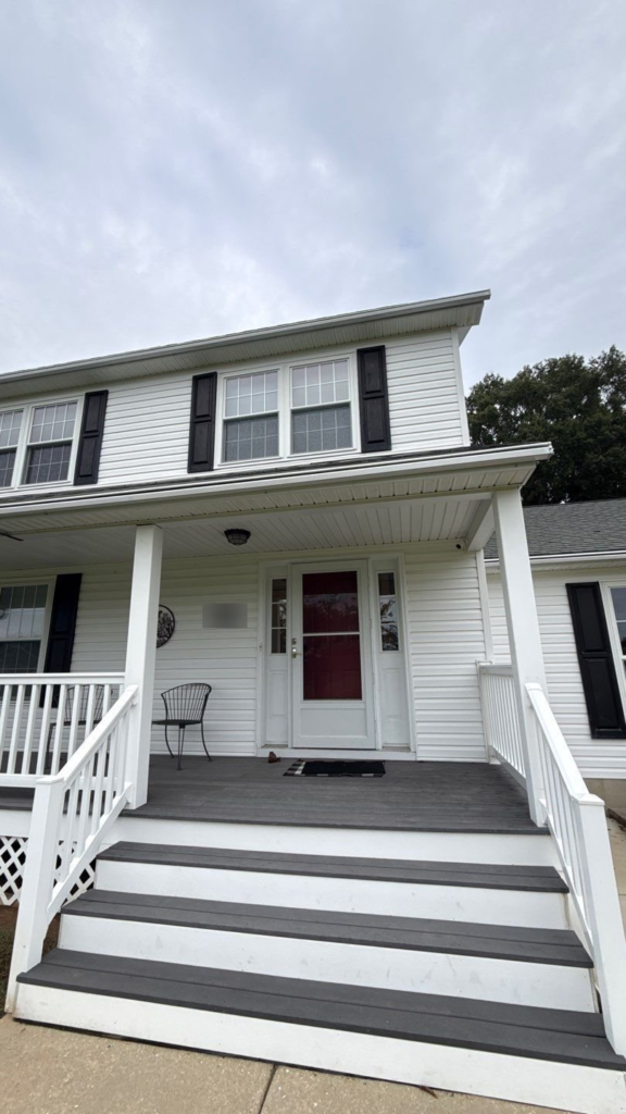 Front of a two-story home with first and second story shutters painted black