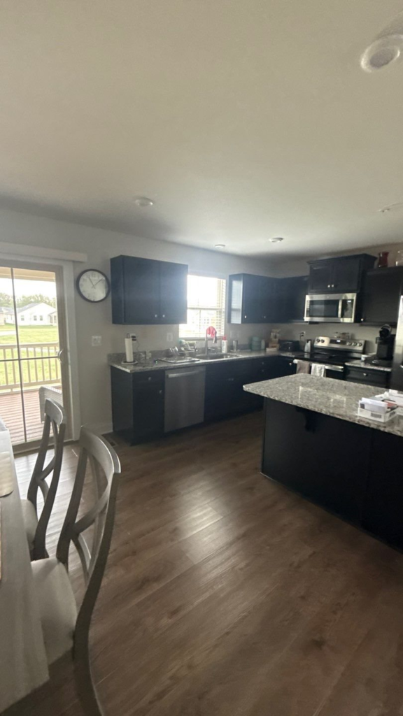 Open-concept kitchen with freshly painted walls flowing into the living space