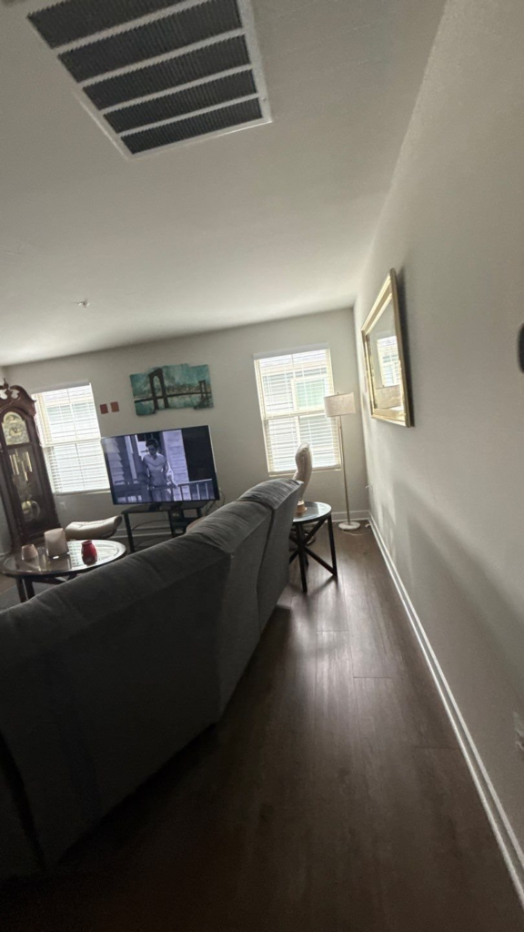 Open-concept living room painted in one continuous wall color